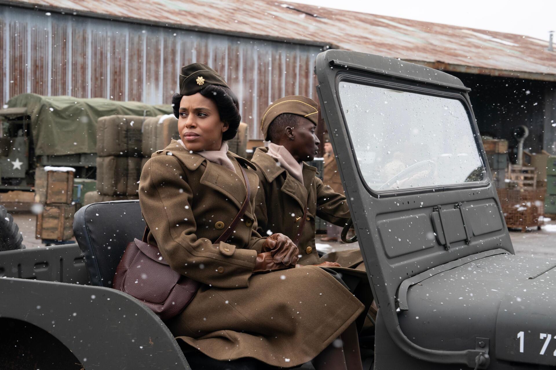 Kerry Washington stars in The Six Triple Eight, depicted here in a 4K Ultra HD scene, sitting in a military jeep with a backdrop of a snowy landscape and supplies.