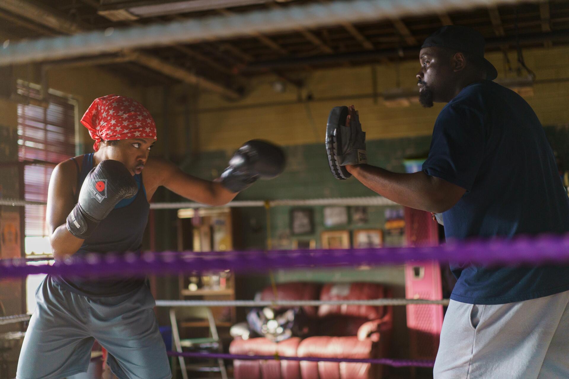 Action-packed scene from the movie The Fire Inside, featuring Ryan Destiny in a boxing training session. 4K Ultra HD desktop wallpaper showcasing determination and grit.