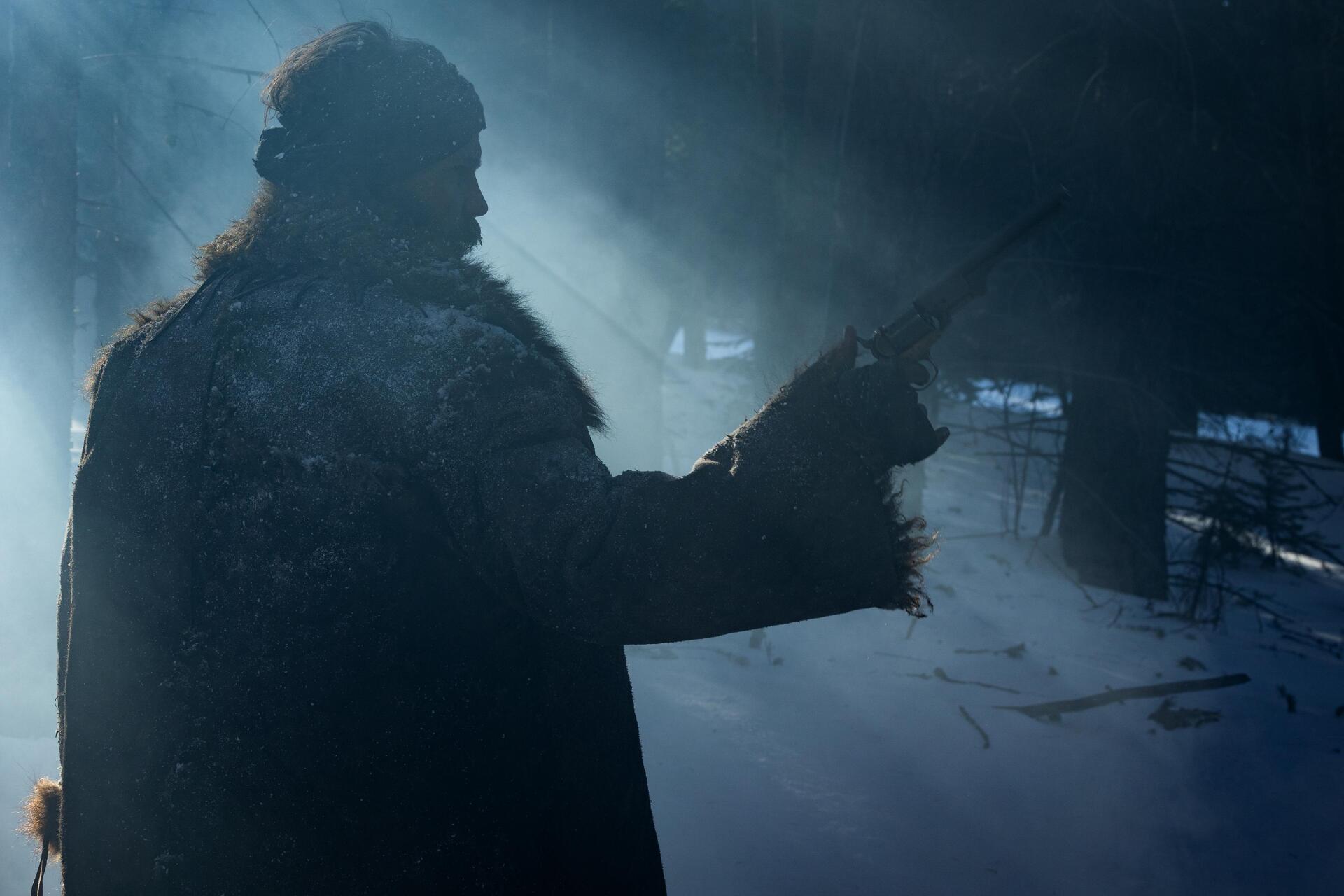 A silhouette of a figure in a fur coat holds a rifle, surrounded by mist and dim light, capturing a dramatic moment from the TV show American Primeval. HD wallpaper.