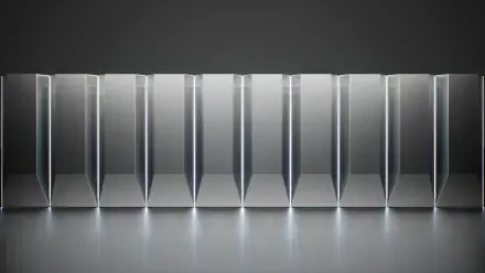 Abstract metallic structures aligned in a row, featuring sleek lines and reflections, create a modern aesthetic. This 4K Ultra HD wallpaper captures a Tesla data center vibe.