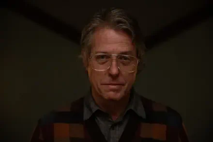 Hugh Grant stars in Heretic (2024), depicted here in a dramatic 4K Ultra HD Desktop Wallpaper, showcasing his intense expression and distinctive style.