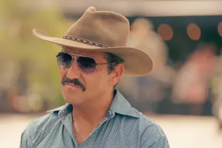 A character from the TV show Tulsa King wearing a cowboy hat and sunglasses, captured in a vibrant 4K Ultra HD setting, showcasing a distinctive style.