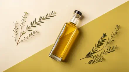 A glass bottle of olive oil sits prominently on a geometric background with olive leaves arranged nearby, showcasing a fresh and natural aesthetic in this 4K Ultra HD wallpaper.