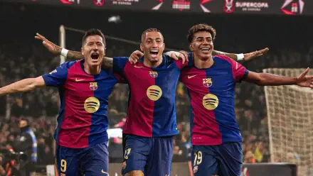 Lamine Yamal, Robert Lewandowski, and Raphael Dias Belloli celebrate on the field in vibrant FC Barcelona kits in this HD PC desktop wallpaper.