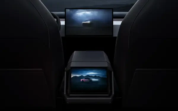 Interior view of a Tesla Cybertruck showcasing its sleek design and advanced screens, set against a dramatic backdrop. This 4K Ultra HD image serves as a striking desktop wallpaper.