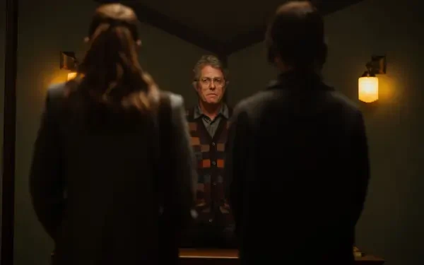 Hugh Grant stars in Heretic (2024), captured in this intense scene featuring two silhouettes confronting him, set in a dimly lit room. 4K Ultra HD desktop wallpaper.