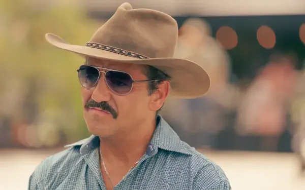 A character from the TV show Tulsa King wearing a cowboy hat and sunglasses, captured in a vibrant 4K Ultra HD setting, showcasing a distinctive style.