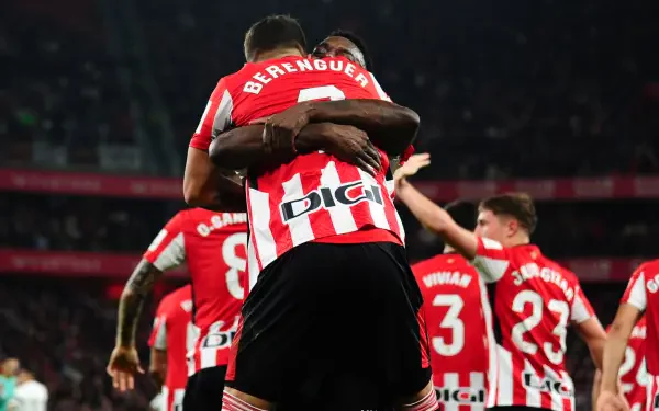 Athletic Club players celebrate a goal in a vibrant soccer moment, showcasing team spirit and athleticism. This dynamic HD wallpaper captures the excitement of the sport.