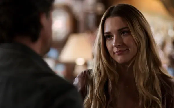 A scene from the TV show Virgin River (2019) featuring Alexandra Breckenridge, capturing an intimate moment with an engaging expression, set in a cozy interior.