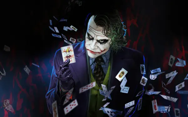 HD PC desktop wallpaper featuring the Joker holding a card, surrounded by flying playing cards in a dark, dramatic setting.