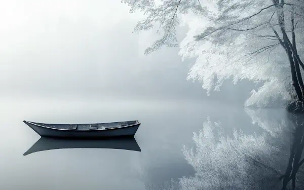 A tranquil scene of a lone boat floating on a serene lake, surrounded by misty trees, captured in stunning 4K Ultra HD for a peaceful desktop wallpaper.