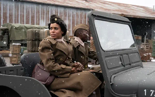 Kerry Washington stars in The Six Triple Eight, depicted here in a 4K Ultra HD scene, sitting in a military jeep with a backdrop of a snowy landscape and supplies.