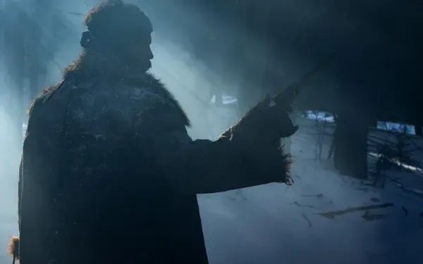 A silhouette of a figure in a fur coat holds a rifle, surrounded by mist and dim light, capturing a dramatic moment from the TV show American Primeval. HD wallpaper.