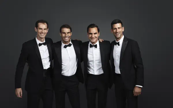 A stylish 4K Ultra HD desktop wallpaper featuring tennis champions Andy Murray, Rafael Nadal, Roger Federer, and Novak Djokovic, all dressed in tuxedos against a dark backdrop.