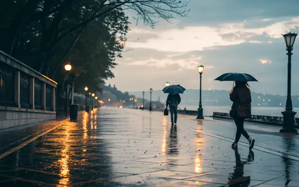 A serene, rainy day scene featuring people walking with umbrellas along a reflective, wet sidewalk, illuminated by street lamps, captured in stunning 4K Ultra HD.