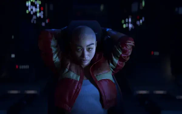 A character from the video game Intergalactic: The Heretic Prophet sits confidently in a dimly lit cockpit, surrounded by glowing controls and screens, creating an engaging HD desktop wallpaper.