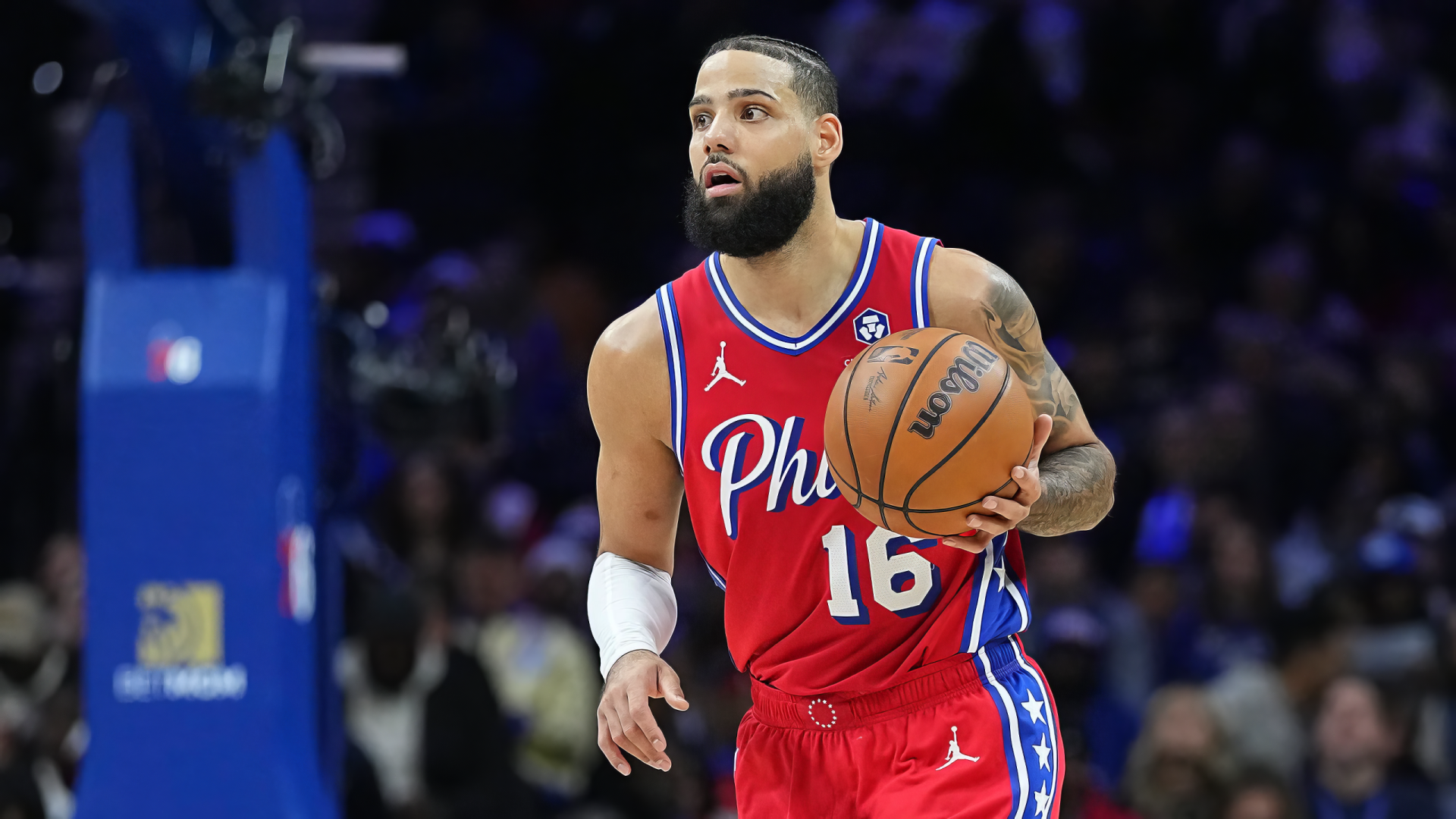 Caleb Martin of the Philadelphia 76ers dribbles a basketball during an NBA game, showcasing his skills on the court in this dynamic HD wallpaper.