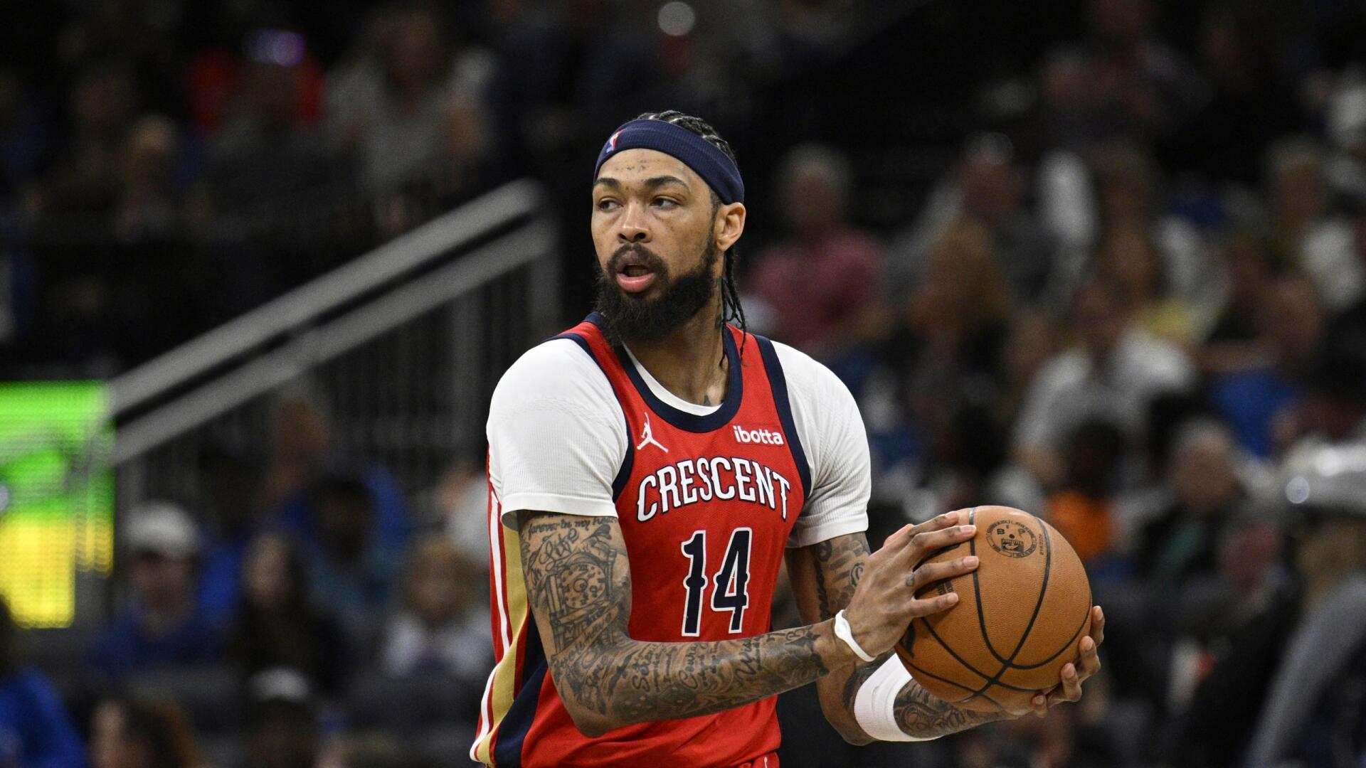 A basketball player in a New Orleans Pelicans jersey dribbles a ball on the court, showcasing the dynamic energy of NBA sports in this HD desktop wallpaper.
