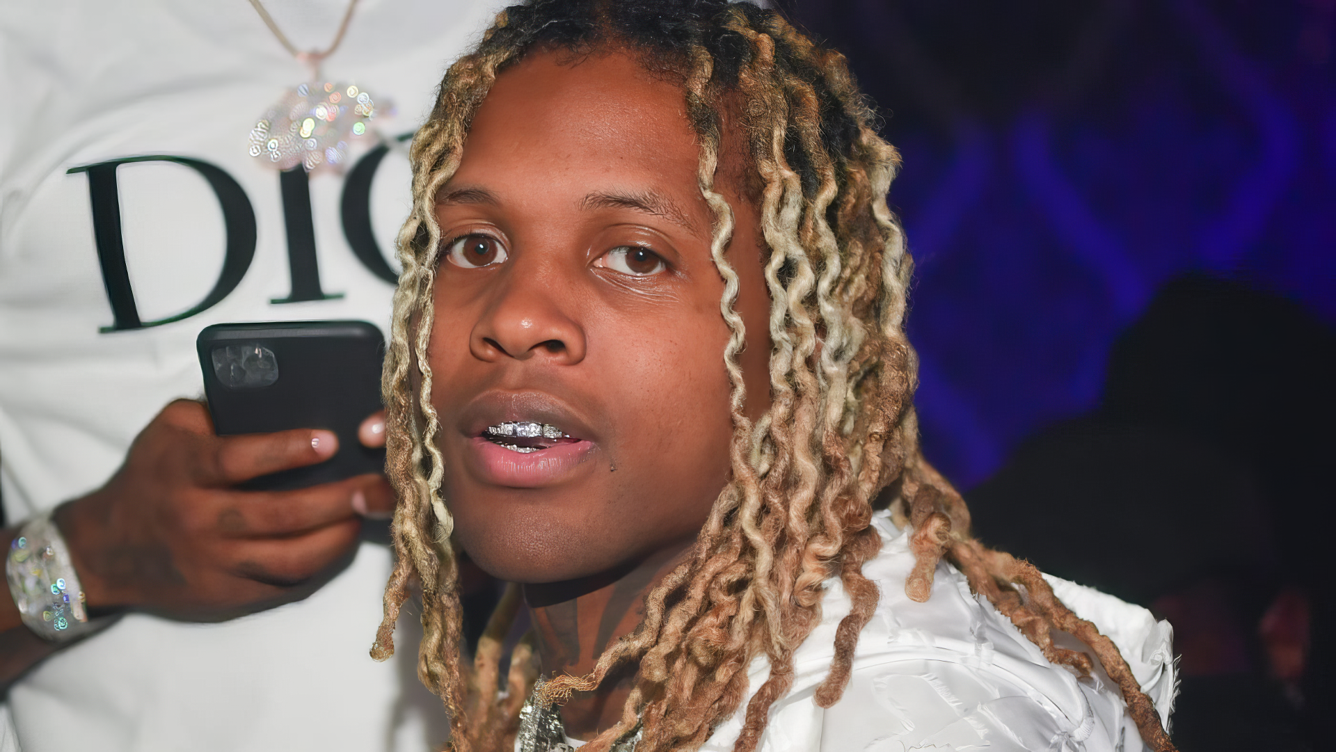 HD PC desktop wallpaper featuring rapper Lil Durk captured in a close-up portrait with distinct blonde dreadlocks and a focused expression.