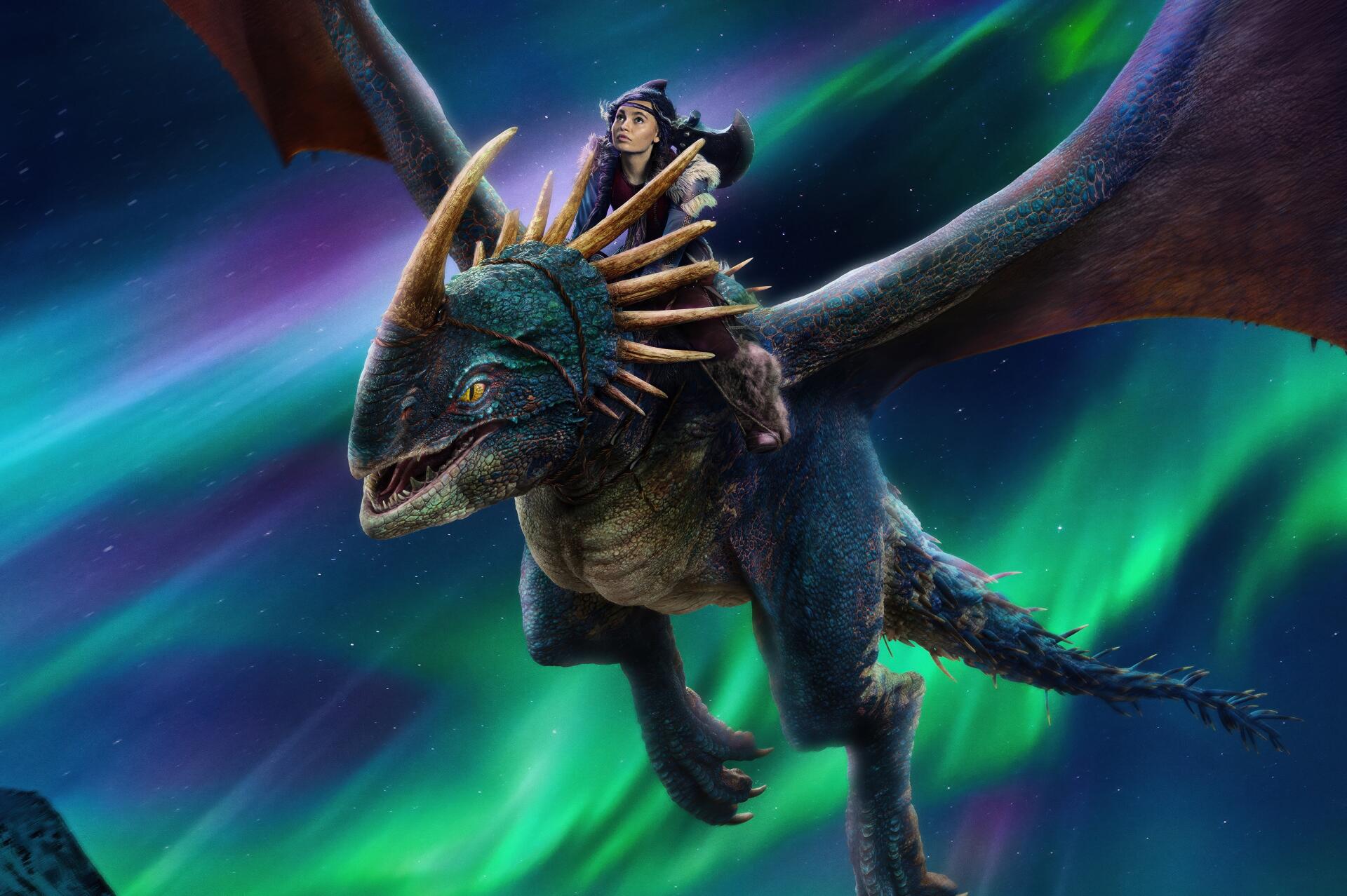 A dragon rider from the movie How to Train Your Dragon soars through the night sky with vibrant northern lights in this 4K Ultra HD desktop wallpaper.