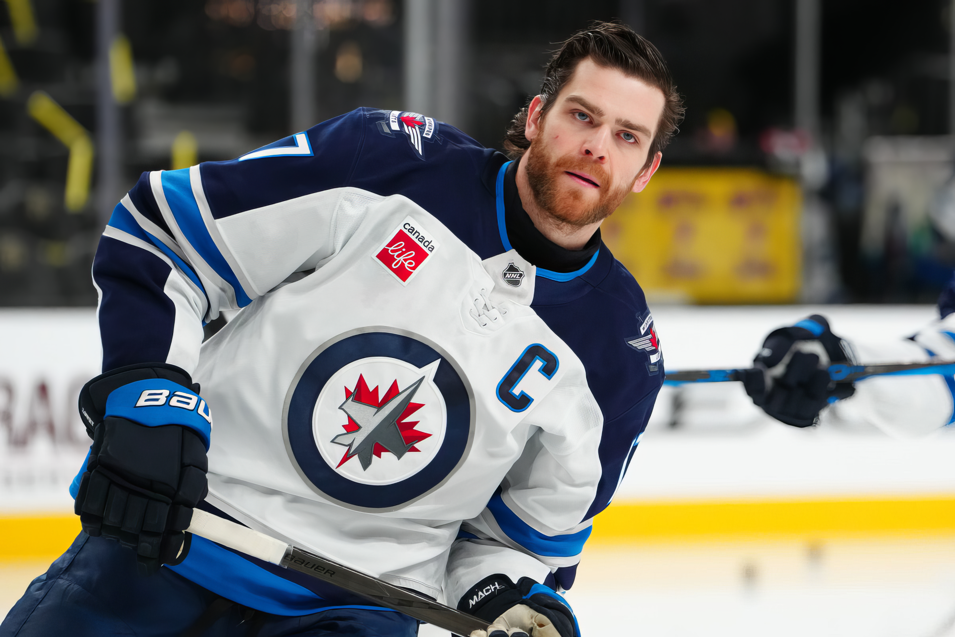 HD desktop wallpaper featuring Adam Lowry of the NHL's Winnipeg Jets in action during a hockey game.
