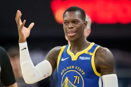 Dennis Schröder gestures playfully while wearing a Golden State Warriors jersey during an NBA game. This HD image captures the dynamic energy of basketball.