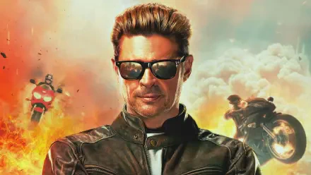 A dynamic 4K Ultra HD wallpaper featuring a character from Mortal Kombat 2 (2025), set against a backdrop of explosions and motorcycles. The character exudes a cool, confident energy.