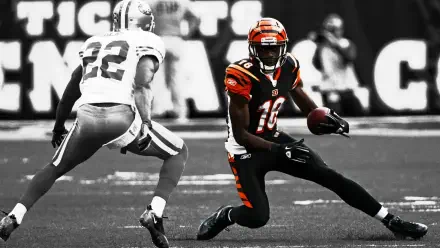 HD PC desktop wallpaper featuring a Cincinnati Bengals football player in black and orange uniform evading a defender during a game.