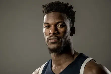 Close-up 4K Ultra HD NBA wallpaper of basketball player Jimmy Butler in his team jersey against a plain background.