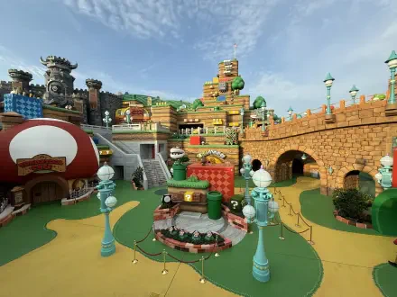 HD PC desktop wallpaper showcasing the colorful, detailed Super Nintendo World area at Universal Studios with vibrant-themed buildings and pathways under a clear sky.