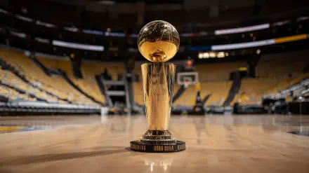 NBA Finals trophy displayed center court on a basketball court, captured in high-definition for a dynamic PC desktop wallpaper background.