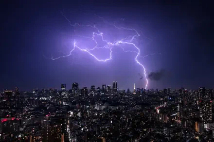 4K Ultra HD nightscape of Tokyo, Japan, with a dramatic lightning bolt illuminating the city skyline in a vibrant photography capture.