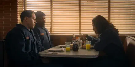 HD PC desktop wallpaper from the movie The Pickup, showing three people sitting at a diner booth with blinds casting warm light inside.