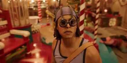 HD PC desktop wallpaper of Usopp from the One Piece live-action TV show: close-up of him in goggles and a headscarf amid a colorful, carnival-like set.