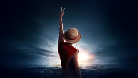 One Piece (Live Action) 4K Ultra HD PC desktop wallpaper: live-action straw-hat pirate raises two fingers toward a sunrise over the sea, silhouetted against a dramatic sky.