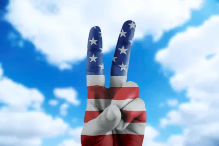 HD PC desktop wallpaper: a hand painted with the American flag making a victory/peace V sign against a bright blue sky, celebrating the 4th of July.