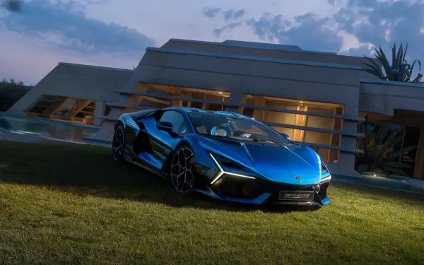 Blue Lamborghini sports car parked on grass in front of a modern house at dusk — 4K Ultra HD PC desktop wallpaper/background.