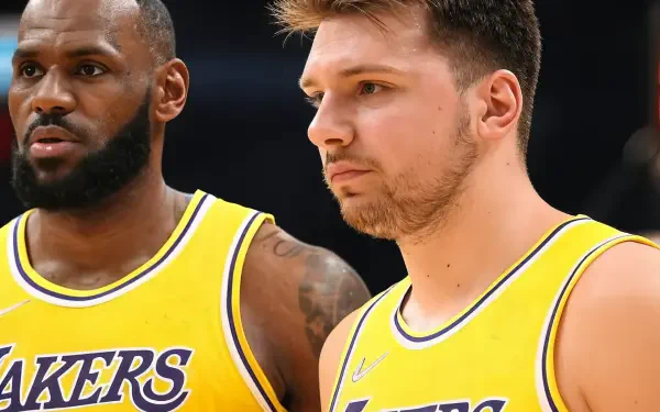 LeBron James and Luka Dončić in Los Angeles Lakers jerseys, focused and ready for action. A vibrant HD wallpaper capturing the energy of NBA sports.
