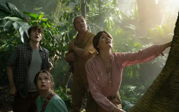 A scene from the movie Paddington in Peru, featuring four characters in lush greenery, gazing upwards with expressions of wonder, enveloped in a warm, inviting light. HD desktop wallpaper.