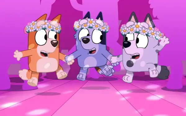 Three animated dogs from the TV show Bluey, adorned with floral crowns, joyfully dance together on a vibrant pink background. A lively scene for a HD PC desktop wallpaper.