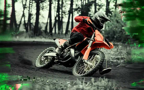 A rider maneuvers a vibrant orange dirt bike on a rugged trail, surrounded by trees, captured in stunning 4K Ultra HD for a dynamic desktop wallpaper.