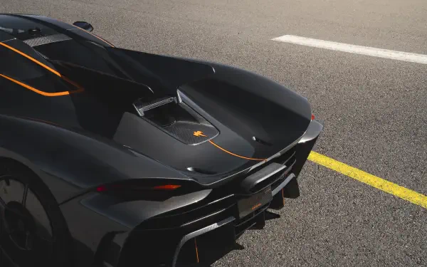 A striking Koenigsegg Jesko Absolut hypercar displayed on a smooth road, showcasing its sleek design and vibrant orange accents. 8K Ultra HD wallpaper.