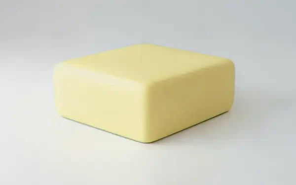 A close-up of a smooth, yellow block of butter against a neutral background, designed as a 4K Ultra HD PC desktop wallpaper and background.