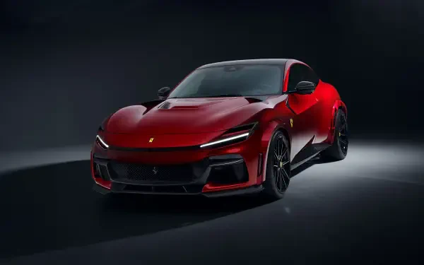 A striking red Ferrari Purosangue showcases its sleek design in this 4K Ultra HD wallpaper, highlighting the luxury and power of this iconic car against a dark backdrop.