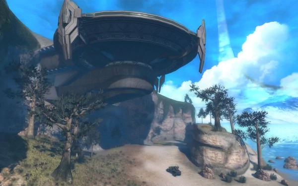 HD PC desktop wallpaper from the video game Halo: Combat Evolved Anniversary — Forerunner structure on sunlit cliffs above a sandy beach beneath a bright blue sky.