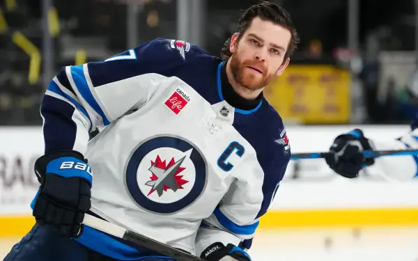 HD desktop wallpaper featuring Adam Lowry of the NHL's Winnipeg Jets in action during a hockey game.