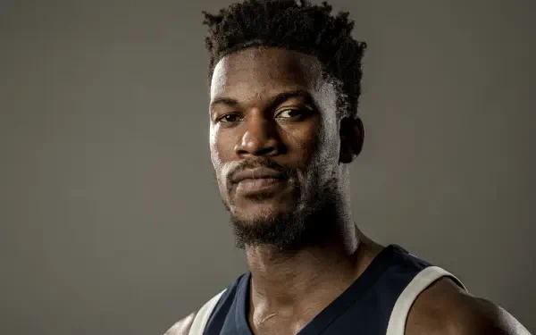 Close-up 4K Ultra HD NBA wallpaper of basketball player Jimmy Butler in his team jersey against a plain background.