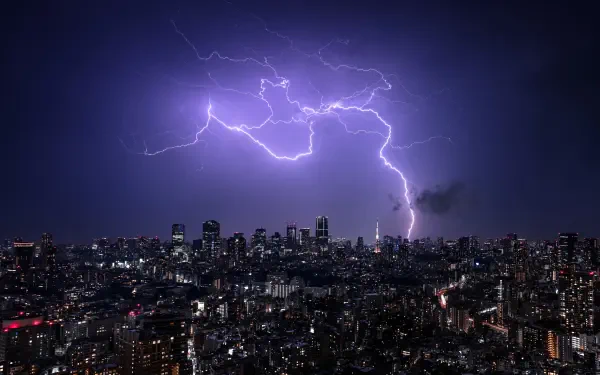 4K Ultra HD nightscape of Tokyo, Japan, with a dramatic lightning bolt illuminating the city skyline in a vibrant photography capture.