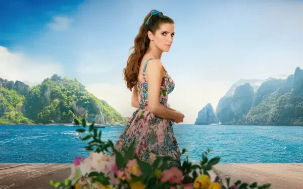 Anna Kendrick in a vibrant floral dress stands on a wooden deck overlooking a serene ocean and lush green islands, from the movie Another Simple Favor in 4K Ultra HD.