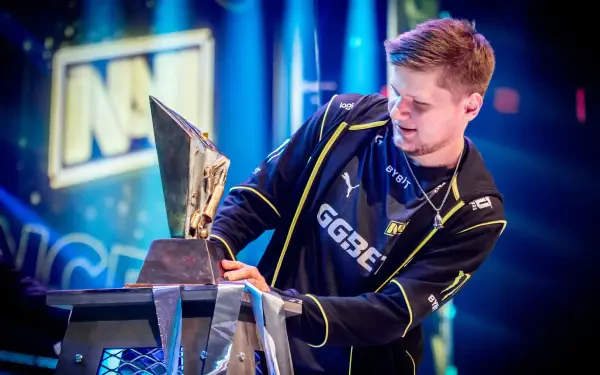HD esports desktop wallpaper featuring s1mple from Natus Vincere holding a trophy, with vibrant blue lighting and the NAVI logo in the background.
